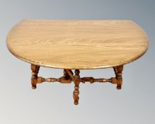 An Ercol drop leaf coffee table on turned legs