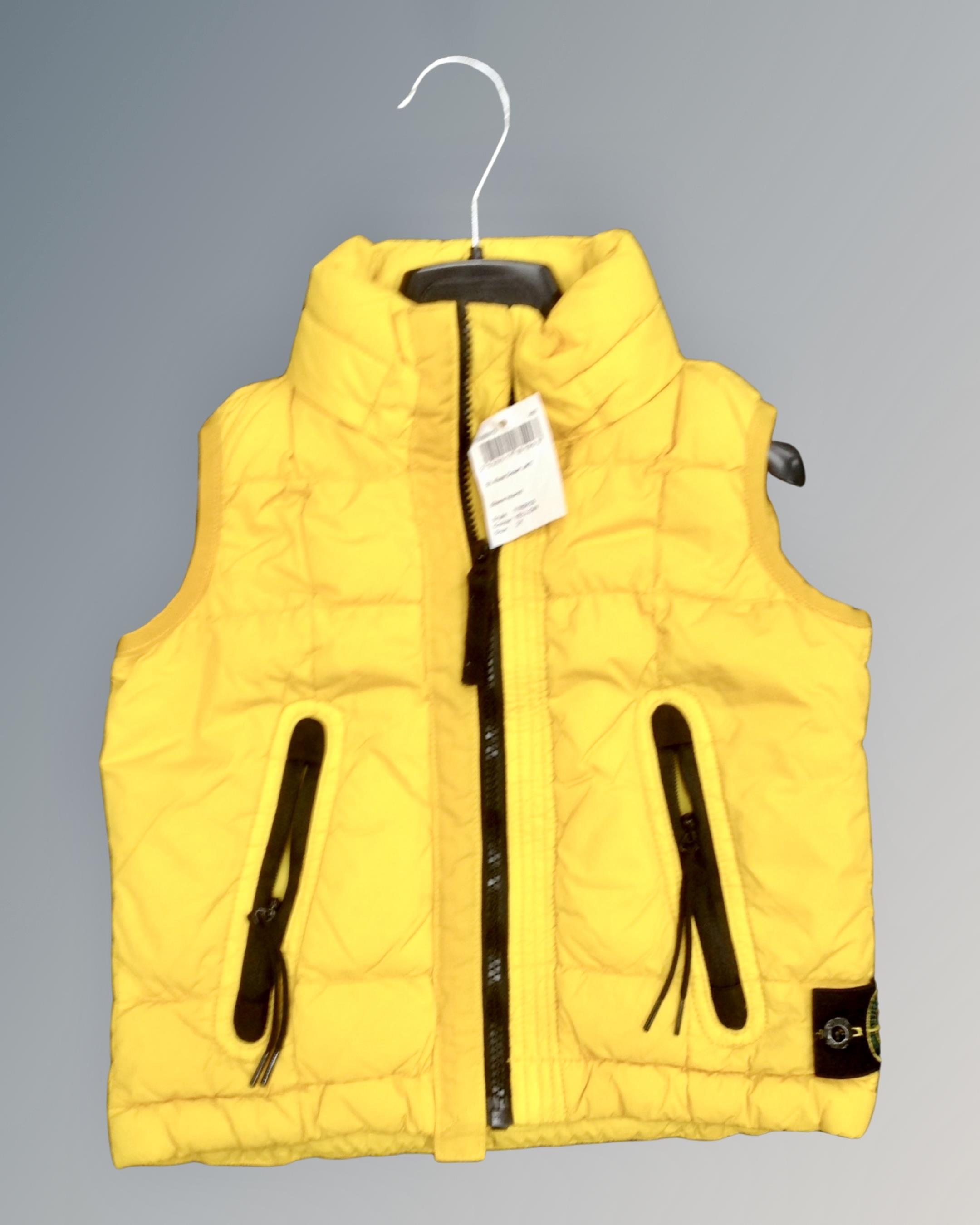 A Stone Island junior real down gilet, yellow size 2Y, tagged and new.