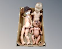 A box of three early 20th century dolls