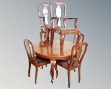 A Victorian style mahogany circular dining table together with six dining chairs