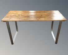 An industrial style stained pine plank top table on metal legs CONDITION REPORT: