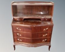 A mahogany serpentine fronted three drawer chest