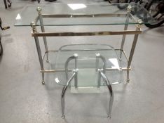 A contemporary glass and metal two tier console table together with similar lamp table