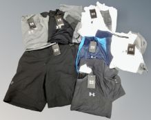 Six Under Armour sports tops together with a pair of shorts, tagged and new,
