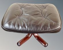 A mid century brown leather footstool