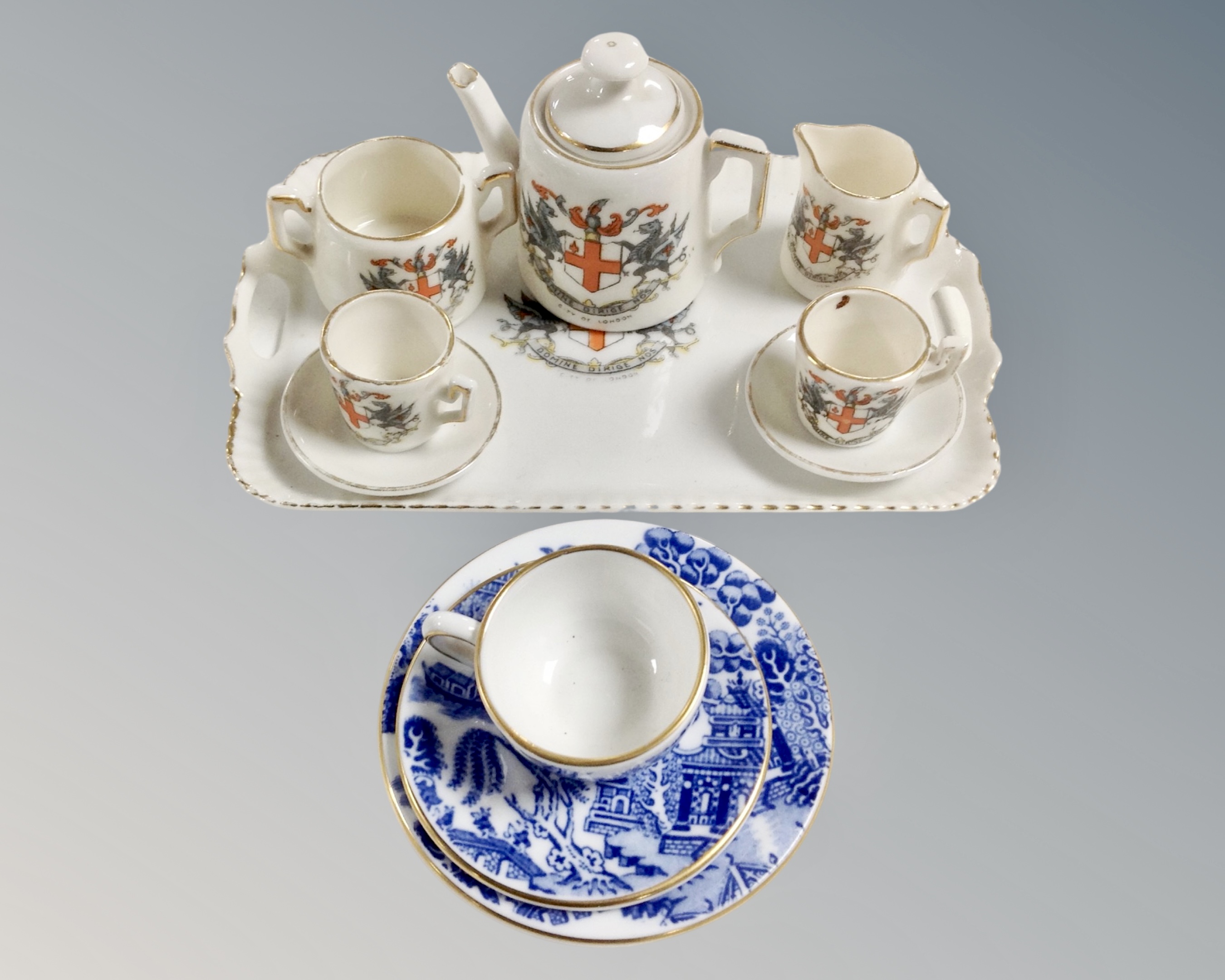 A crested ware miniature tea for two on tray with the arms of the city of London together with