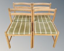 A set of six oak dining chairs in green striped upholstery