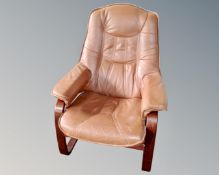 A 20th century Scandinavian tan leather armchair