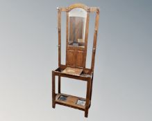 An early 20th century oak mirrored hall stand