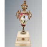 A Victorian porcelain and gilt mantel urn on onyx stand