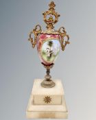 A Victorian porcelain and gilt mantel urn on onyx stand