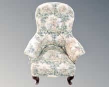 A 19th century floral upholstered armchair