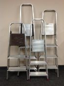 Four sets of folding aluminium step ladders