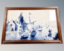 An early 20th century Delft blue and white porcelain plaque depicting a Dutch harbour scene, framed.