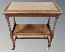 An Edwardian oak two tier trolley