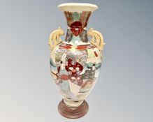 An early 20th century Japanese twin handled urn, height 54cm.