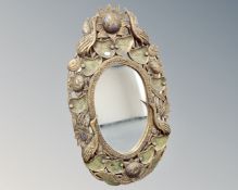 A decorative framed oval mirror