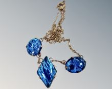 A vintage Art Deco blue butterfly wing necklace in rolled gold