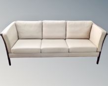 A Scandinavian three seater and two seater beige leather settees