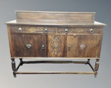 An Edwardian carved oak sideboard