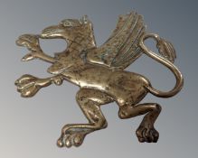 A 19th century brass plaque depicting a Welsh dragon, 19.5cm by 17cm.