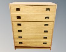 An early 20th century oak six drawer chest with brass handles
