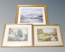 A W Wilson watercolour depicting figures by a river with dwellings beyond in gilt frame together