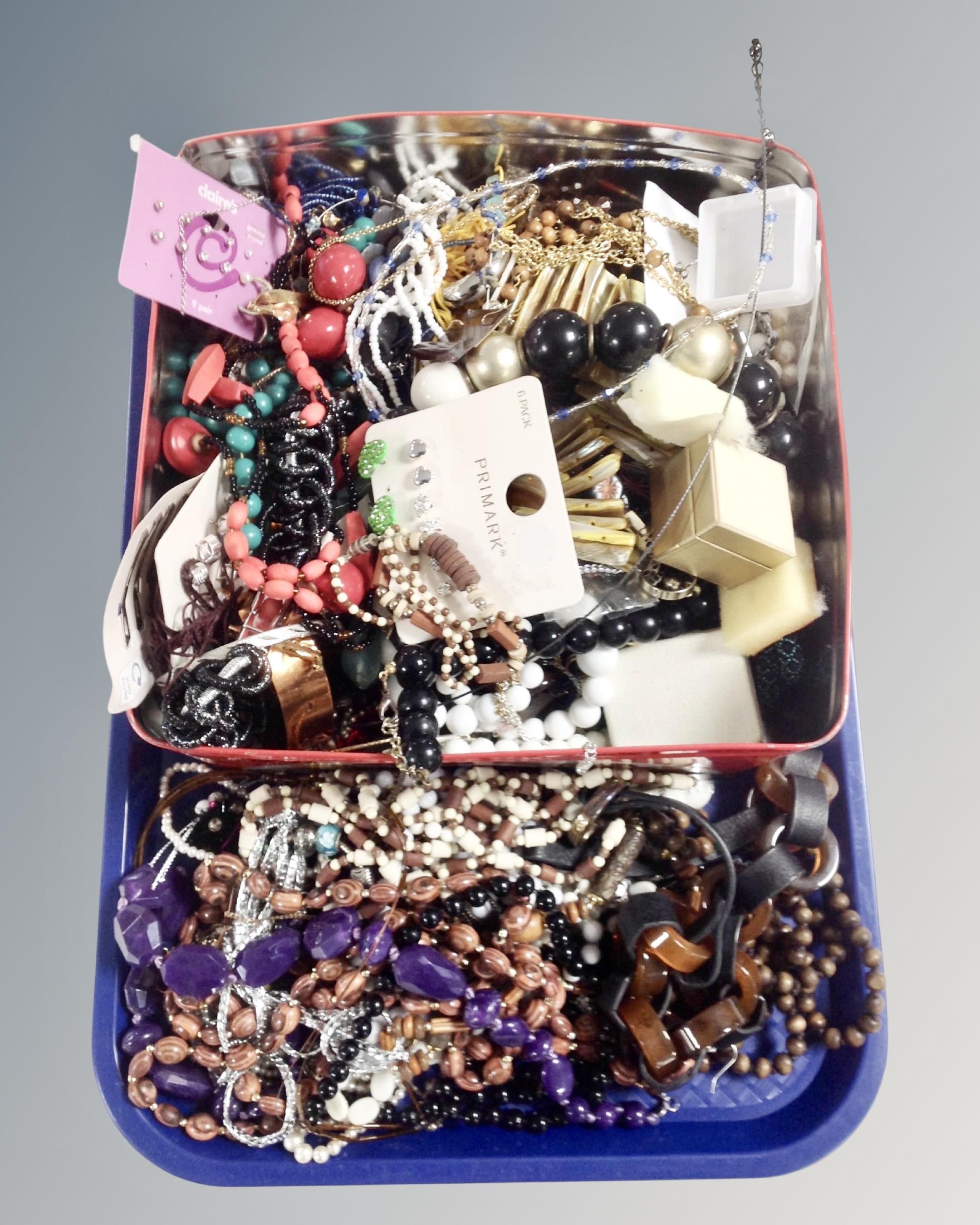 A tray of large tin of costume jewellery etc