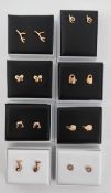 8 boxed pairs of gold plated earrings.