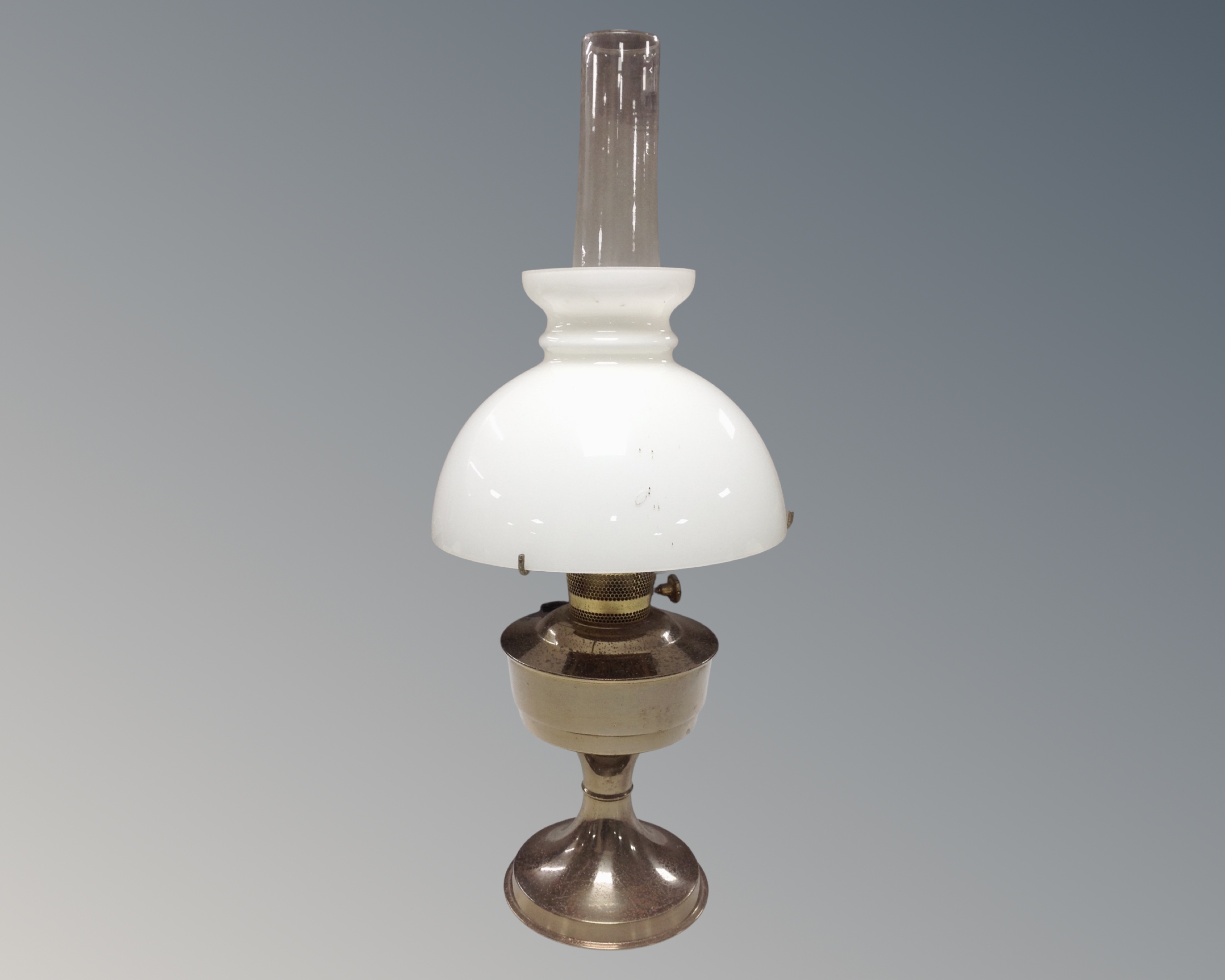 An Aladdin chrome oil lamp with chimney and shade