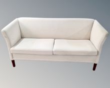 A Scandinavian two seater settee with matching armchair in oatmeal fabric