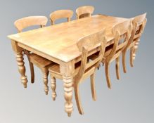 A pine farmhouse dining table together with six chairs