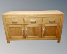 A contemporary oak triple door sideboard