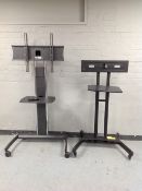 Two portable television stands with brackets