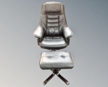 A contemporary black leather swivel chair with footstool