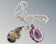 A rough polished amethyst pendant set in silver,