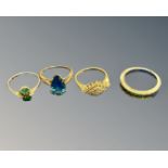 Four dress rings to include - 9ct yellow gold ring set with a blue tear drop shaped stone,