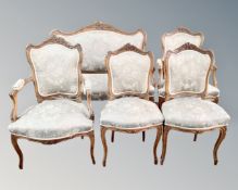 A five piece walnut framed salon suite comprising of settee,