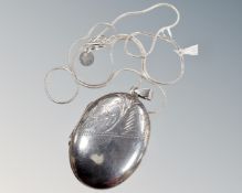 A silver locket on silver snake chain 16.