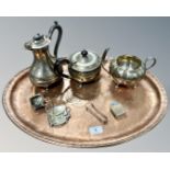 An oval copper tray, diameter 55cm, together with a group of plated wares including teapot, tongs,