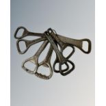 A group of vintage bottle openers bearing advertising including Guinness, Duddingston Ales, Invicta,