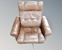 A Scandinavian brown studded leather armchair