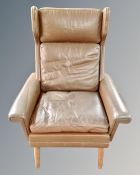 A mid century brown leather Scandinavian armchair