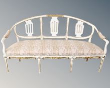 A 19th century painted and gilded three seater salon settee