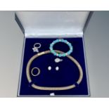 A costume necklace in case together with further bracelet,