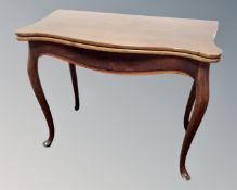 A 19th century shaped mahogany tea table on cabriole legs