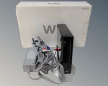 A boxed Playstation II together with Nintendo Wii