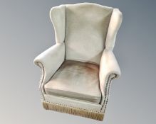 An early 20th century green dralon upholstered armchair