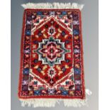 A small Iranian hearth rug 64 cm x 40 cm