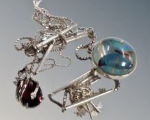 A silver chain with glass double bull's eye enclosing butterfly,